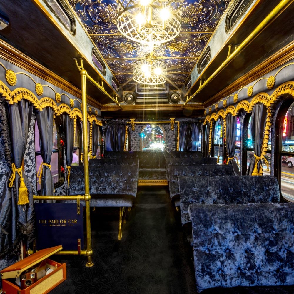 Night interior — chandeliers, gold ceiling and navy velvet seats