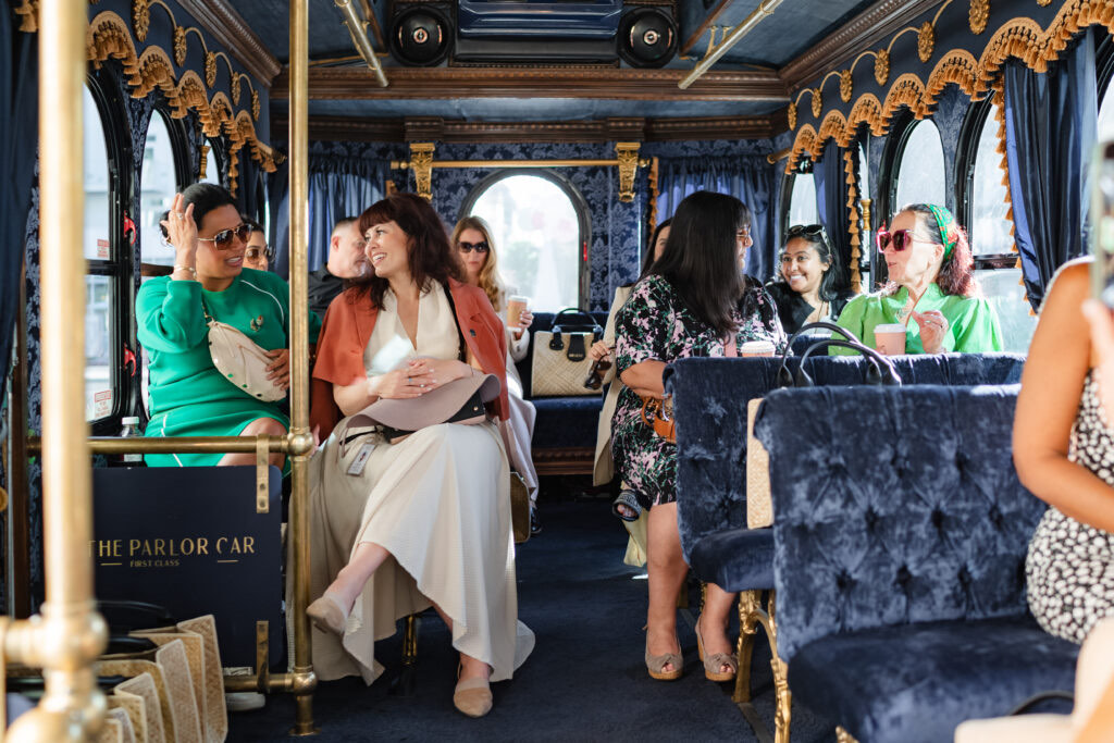 Guests celebrating inside the Parlor Car trolley on navy velvet seats