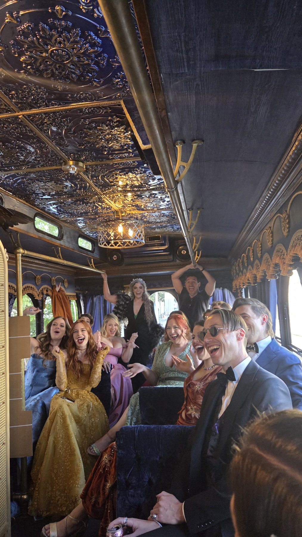 Wedding guests celebrating inside the luxury trolley interior