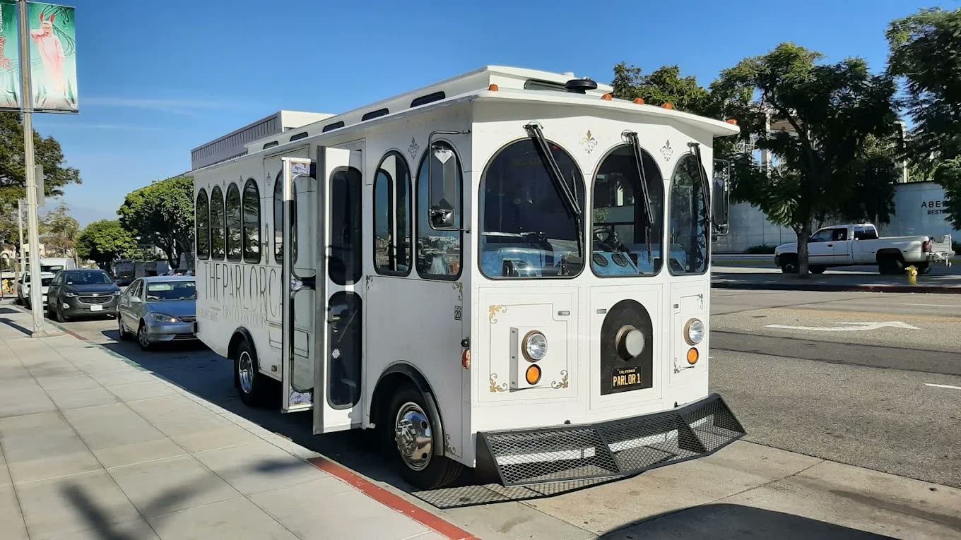 The Parlor Car trolley waiting curbside with its door open