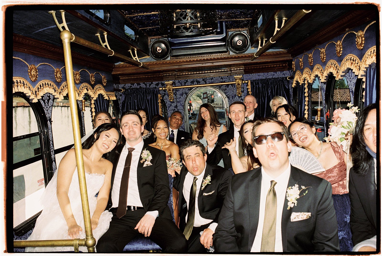 Wedding party celebrating inside the chandelier-lit trolley